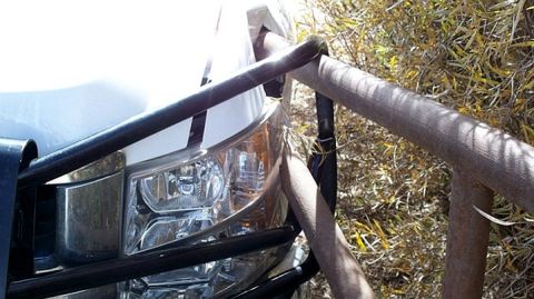 1979 Chevrolet Blazer - Front view of a white truck with a brush guard obscuring the headlight and grille area.