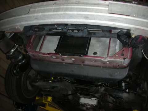 1992 Ford Crown Victoria - Underside view of an intercooler installation project, showing custom piping and vehicle components.
