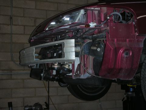 1992 Ford Crown Victoria - The front end of a 1992 Ford Crown Victoria is shown with its bumper removed, revealing the intercooler and other components.
