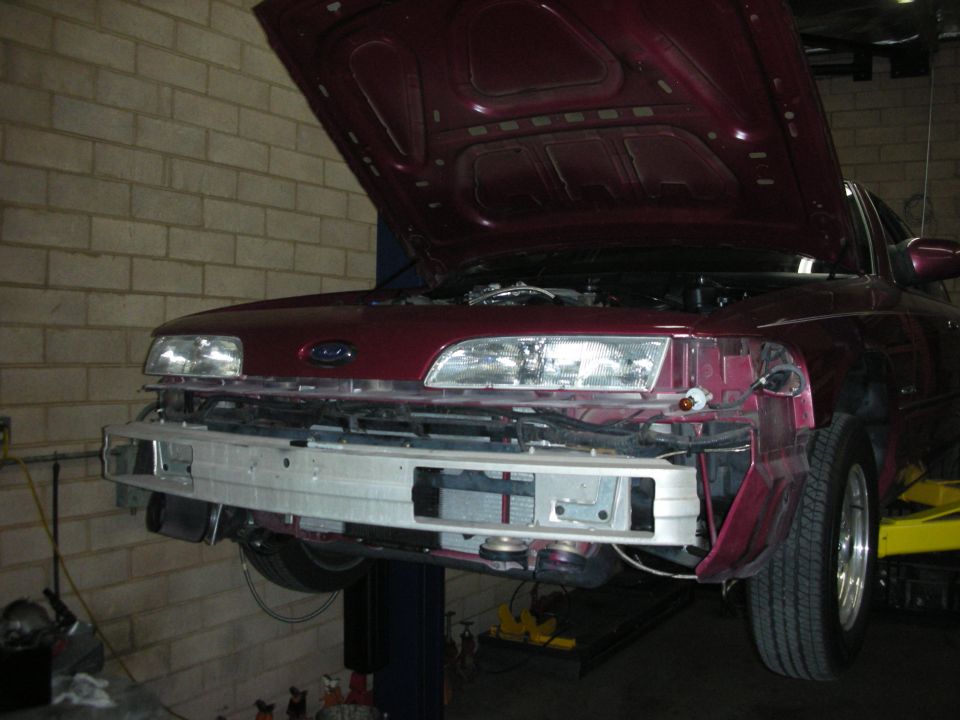 1992 Ford Crown Victoria front end with bumper removed, hood up
