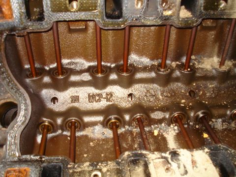1993 Ford Bronco - This is a close-up view of an engine block, revealing pushrods and some identifying markings cast into the metal.