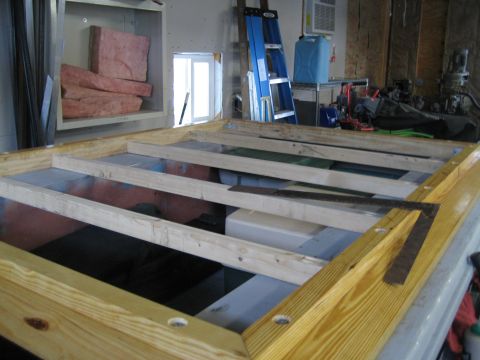 1996 Ford Bronco - Construction in progress, showing a wooden frame with tools and building materials in a workshop setting.