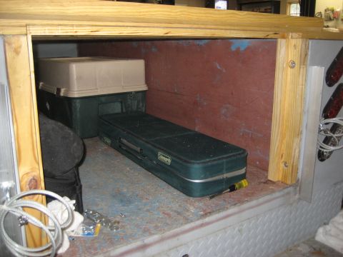 1996 Ford Bronco - Storage containers and a green case are visible inside a trailer compartment.