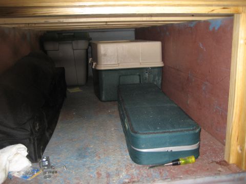 1996 Ford Bronco - Storage area with multiple containers and a black bag visible. A screwdriver is on the floor.