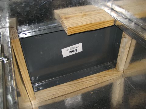 1996 Ford Bronco - A close-up view of a metal box with wooden bracing, showing a label with company information.