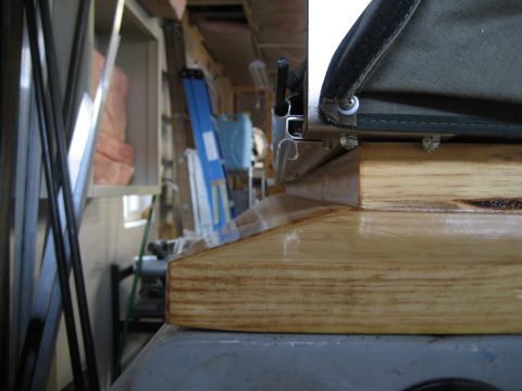 1996 Ford Bronco - Detail of a canvas top's attachment mechanism, showing metal and wood components.