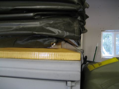 1996 Ford Bronco - A close-up view of stacked tarps and a trailer, with a window in the background.