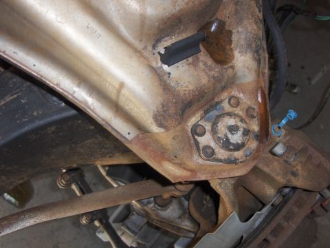 1971 Chevrolet Camaro - This image shows a close-up view of a rusty vehicle suspension component, likely from the undercarriage.
