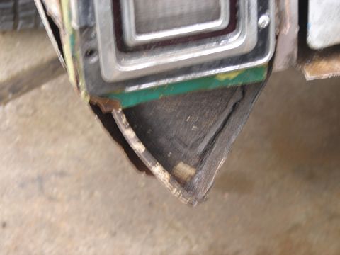 1973 Ford Ranchero - The corner of a vehicle's tail light assembly shows damage and exposed interior components.