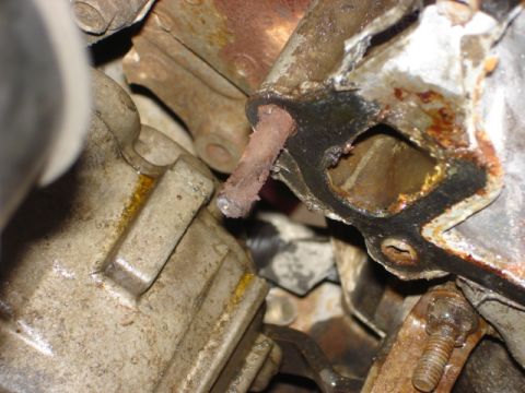 1992 Ford Bronco - Detail of a corroded engine component, possibly a gasket or manifold section.