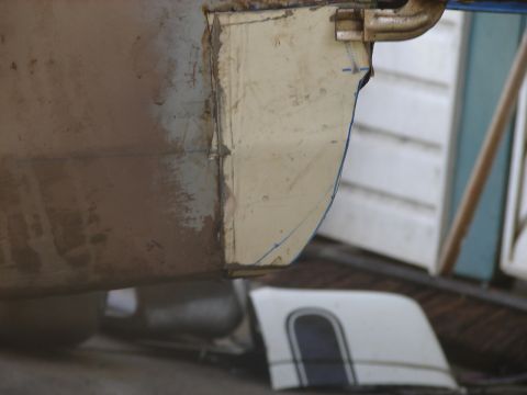 1973 Ford Ranchero - Close-up of a 1973 Ford Ranchero quarter panel undergoing repair, with a detached trim piece visible.
