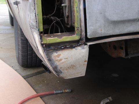 1973 Ford Ranchero - This photo shows a vehicle's rear quarter panel undergoing repair with fresh welds and exposed wiring.