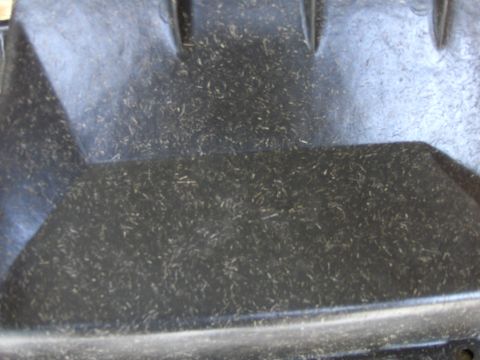 1970 Chevrolet Camaro - A close-up view of a black plastic automotive part covered in debris, with a website watermark visible.