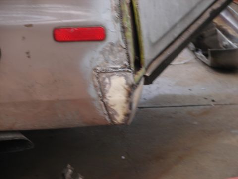 1973 Ford Ranchero - This image shows the rear corner of a vehicle with a red reflector and evidence of bodywork repairs, including welding and filler.