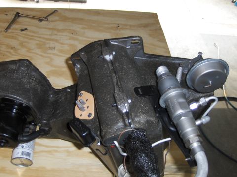 1970 Chevrolet Camaro - Close-up of an automotive part, possibly from a fuel system, with a vacuum actuator attached.