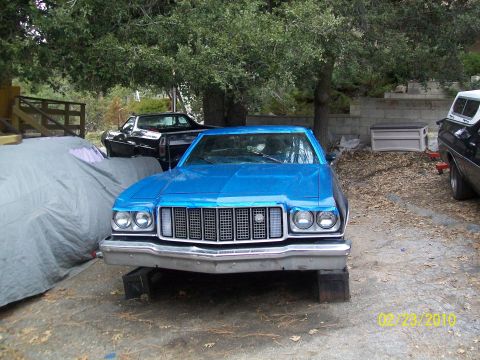 1973 Ford Ranchero - Blue 1974 Ford Ranchero in front of another vehicle, parked outdoors.