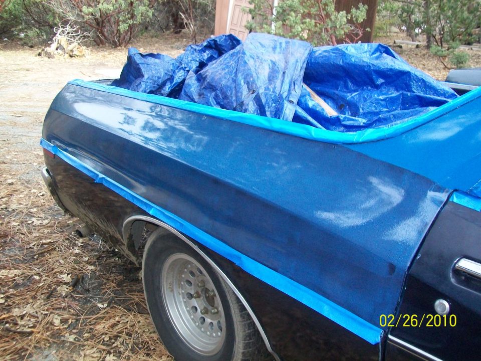 1973 Ford Ranchero rear quarter panel with blue tarp covering bed