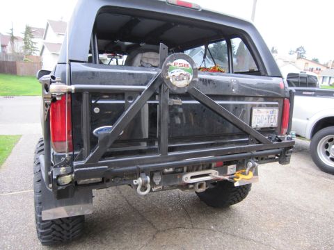 1996 Ford Bronco - This Ford Bronco features a heavy-duty rear bumper with a spare tire mount and a winch, suggesting off-road modifications.