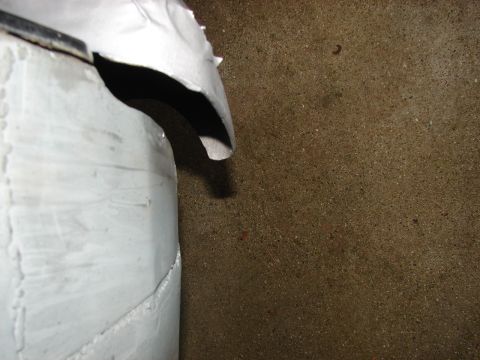 1973 Ford Ranchero - A close-up of a damaged white panel with rivets, showing a dark interior space.
