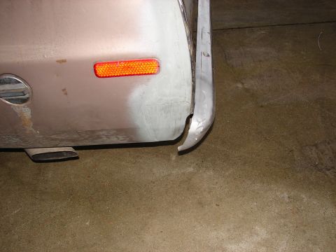 1973 Ford Ranchero - The rear bumper of the vehicle is bent and damaged, with a reflector and exhaust pipe visible.