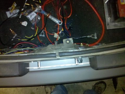 1986 Ford Mustang - A close-up view of a complex vehicle wiring harness with tools scattered around.