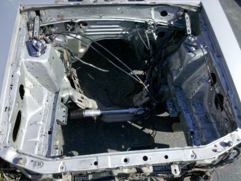 1986 Ford Mustang - The engine bay of a 1986 Ford Mustang shows its internal structure and wiring.