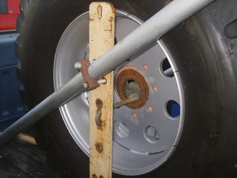 1984 Ford Bronco - Close-up of a vehicle's wheel and tire assembly, showing a silver alloy rim and a large black tire.
