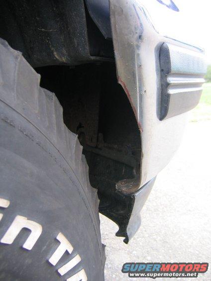 1969 Ford Mustang - A close-up view shows a damaged tire and fender flare, with visible text on the tire.