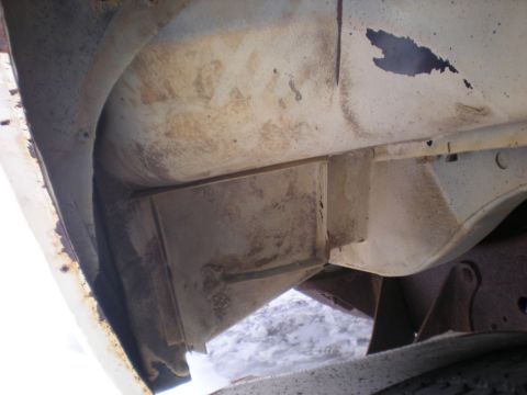 1978 Ford Bronco - Close-up view of the underside of a vehicle, revealing its structural components and signs of wear.