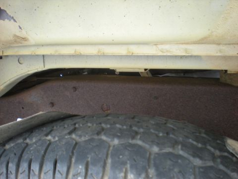1978 Ford Bronco - Close-up view of the vehicle's frame and tire, showing rust.