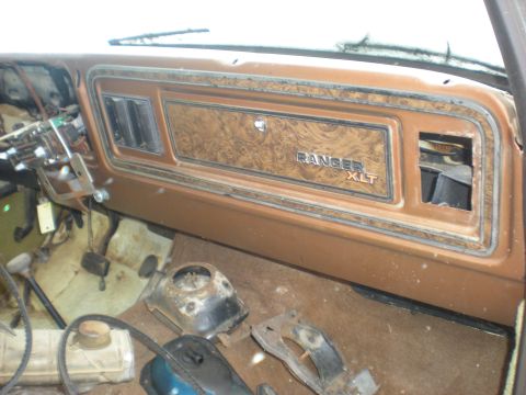 1978 Ford Bronco - The interior dashboard features wood grain trim and a "RANGER XLT" badge, indicating a specific trim level.