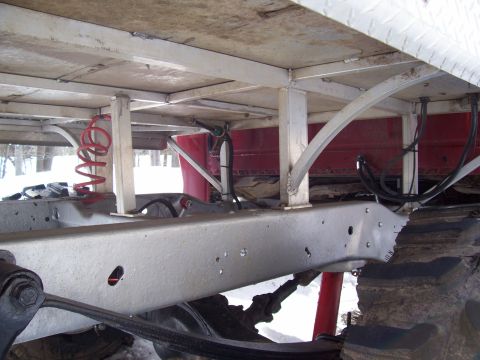 1978 Ford F-150 - Close-up view of the undercarriage of a truck, focusing on the frame and suspension components.