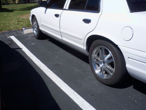 2003 Ford Crown Victoria - Side profile of a white 2003 Ford Crown Victoria parked in a lot.