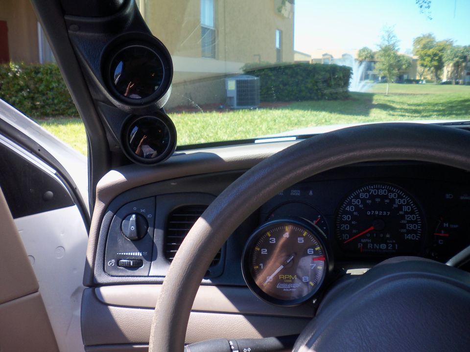 Ford interior with aftermarket Autometer tach and A-pillar gauge pod