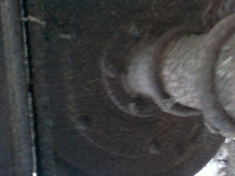 1985 Ford F-150 - A close-up view of a rusty, unidentifiable part of a vehicle's undercarriage.