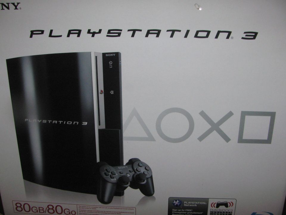 Black Playstation 3 console with controller and 80GB label