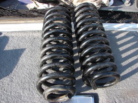 1995 Ford Bronco - Pair of black coil springs, likely for suspension upgrade or replacement.