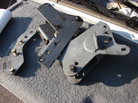 1995 Ford Bronco - Metal components for a lift kit are laid out on a carpeted surface.