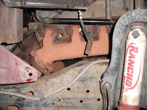 1991 Ford Bronco - Close-up view of engine components including the exhaust manifold and suspension parts.