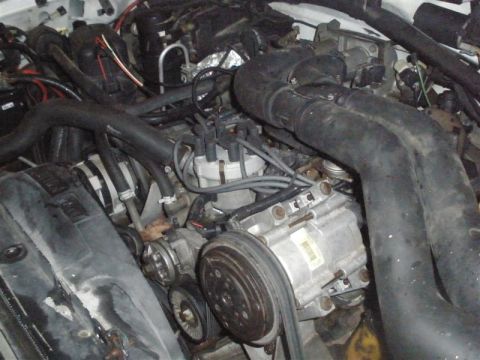 1994 Ford F-350 - Close-up view of a vehicle's engine compartment, showing various mechanical parts and wiring.