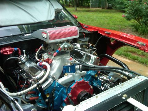 1984 Ford Bronco - Custom V8 engine with a UNI air filter and performance parts, viewed from the engine bay.