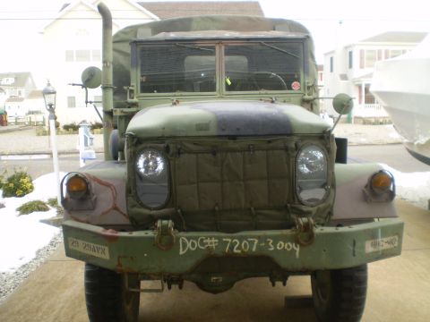 2005 Ford Excursion - This military truck features a camouflage paint scheme and visible markings on its front bumper.