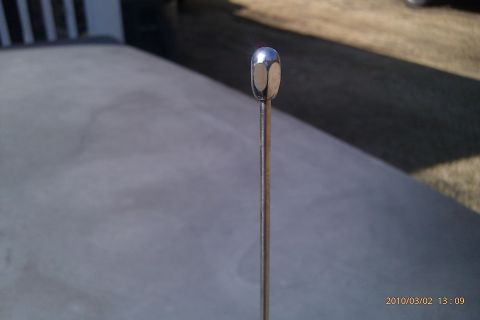 2000 Mercury Grand Marquis - A close-up view of a car's chrome antenna against a blurred background.