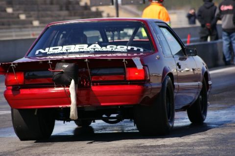 1992 Ford Mustang - Rear view of a red 1992 Ford Mustang modified for drag racing on a track.