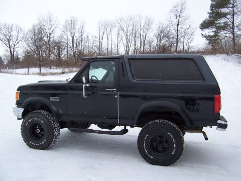 1988 Ford Bronco - This black 1988 Ford Bronco is shown in a snowy outdoor setting.
