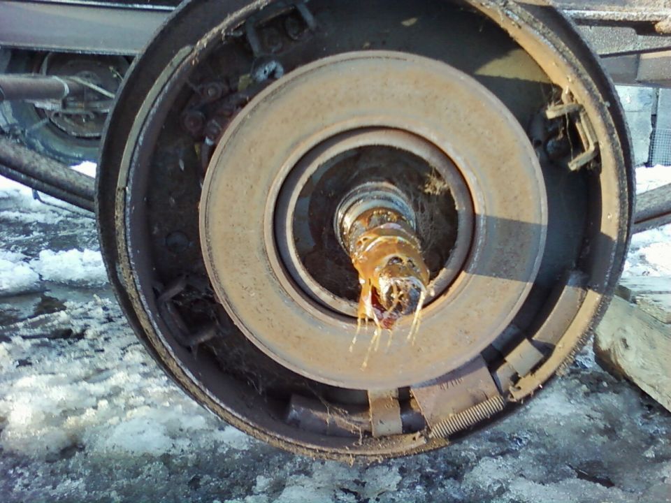 Close-up of a rusty truck brake drum with grease on the spindle