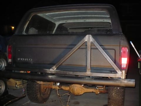 1979 Ford Bronco - Rear view of a 1979 Ford Bronco a custom-built triangular spare tire carrier and a heavy-duty bumper.