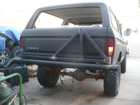 1979 Ford Bronco - This 1979 Ford Bronco features a custom rear bumper and a triangular tire carrier, suggesting off-road modifications.