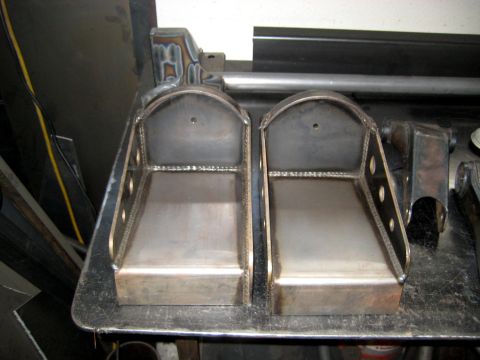 1996 Ford Bronco - Two custom metal brackets are shown, likely for automotive modification or repair.