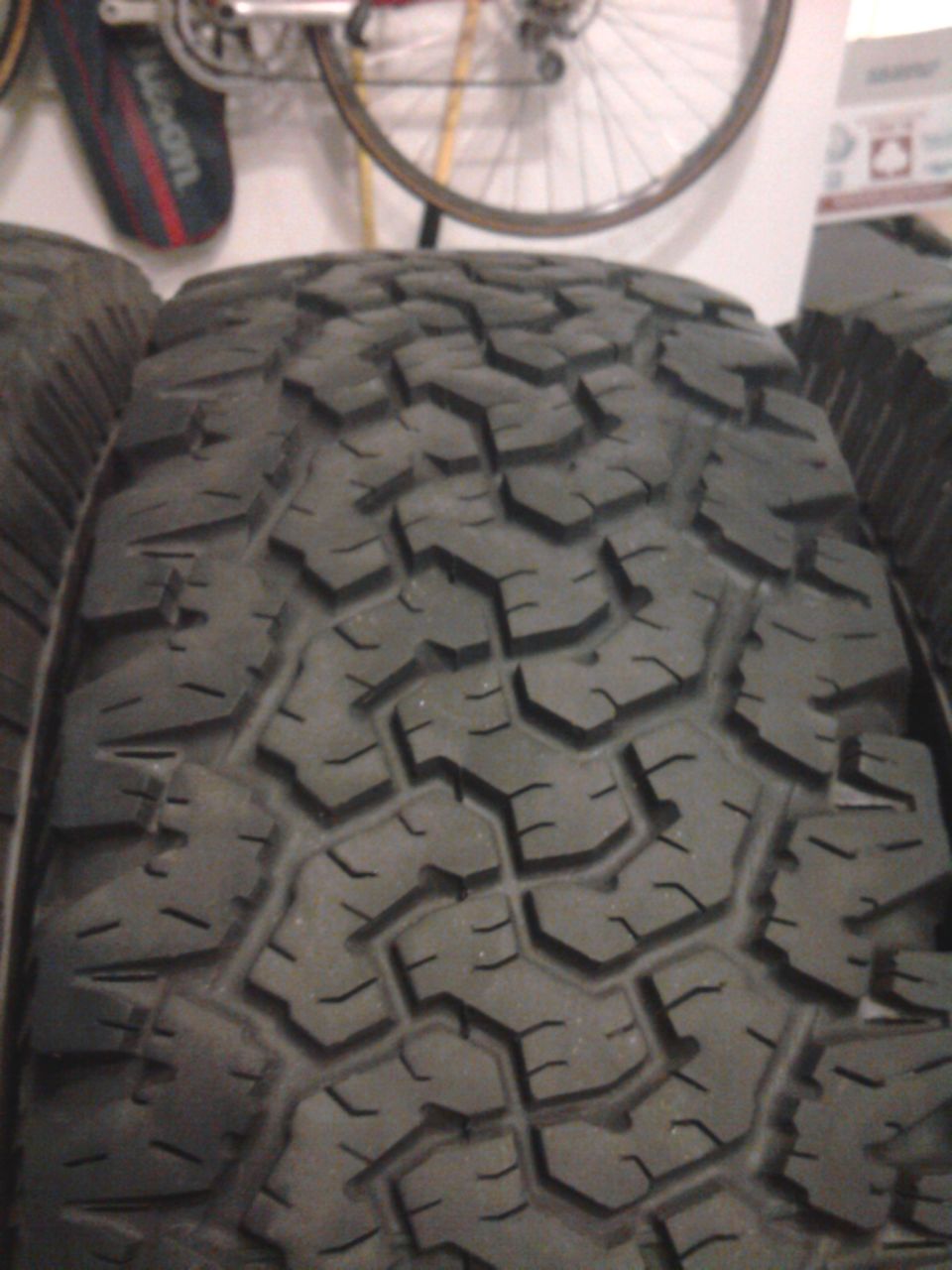 Close-up of an aggressive all-terrain tire tread indoors